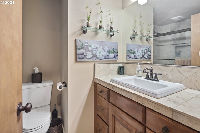 bathroom with walk in shower, vanity, toilet, and backsplash