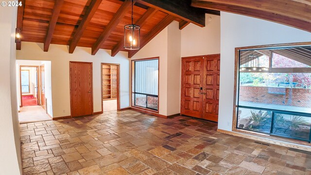 1081 Umpqua College Rd, Roseburg, OR 97470 - foyer with baseboards, high vaulted ceiling, wooden ceiling with exposed beams, and stone tile flooring