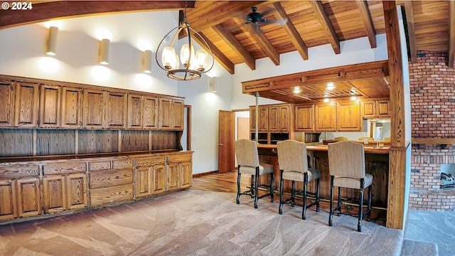 1081 Umpqua College Rd, Roseburg, OR 97470 - kitchen with brown cabinetry, a kitchen bar, high vaulted ceiling, pendant lighting, and wooden ceiling with exposed beams