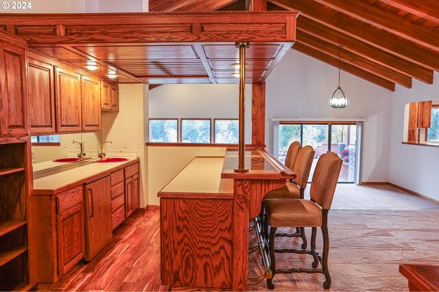 1081 Umpqua College Rd, Roseburg, OR 97470 - kitchen with a sink, healthy amount of natural light, a breakfast bar area, hanging light fixtures, and wooden ceiling