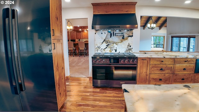 1081 Umpqua College Rd, Roseburg, OR 97470 - kitchen featuring freestanding refrigerator, stainless steel gas range, a chandelier, extractor fan, and recessed lighting
