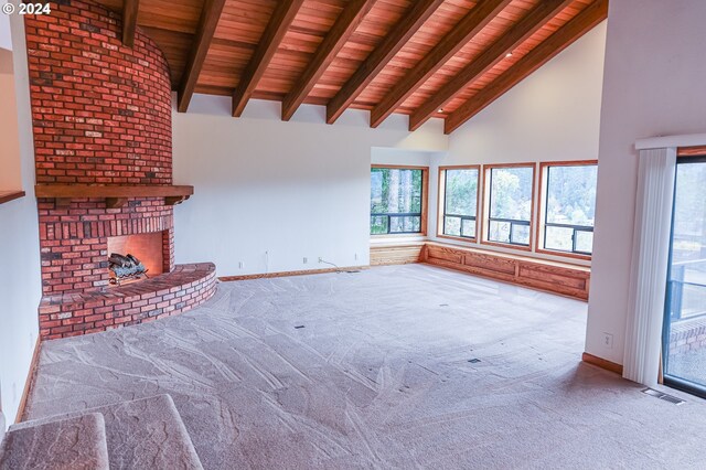 1081 Umpqua College Rd, Roseburg, OR 97470 - unfurnished living room with wooden ceiling with exposed beams, carpet, high vaulted ceiling, a brick fireplace, and baseboards
