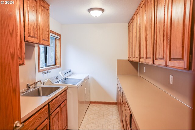1081 Umpqua College Rd, Roseburg, OR 97470 - laundry area featuring separate washer and dryer, cabinet space, baseboards, and light flooring