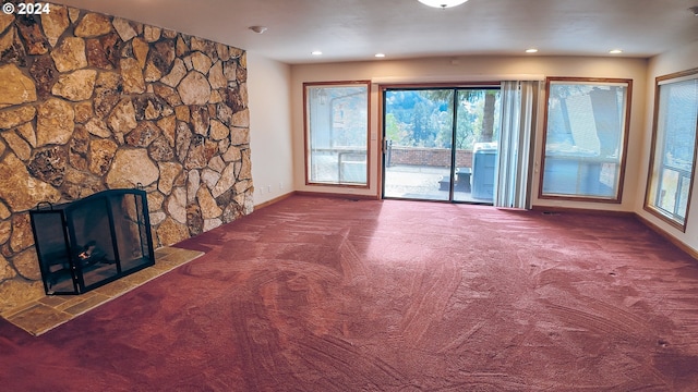 1081 Umpqua College Rd, Roseburg, OR 97470 - unfurnished living room with carpet floors, baseboards, recessed lighting, plenty of natural light, and a fireplace