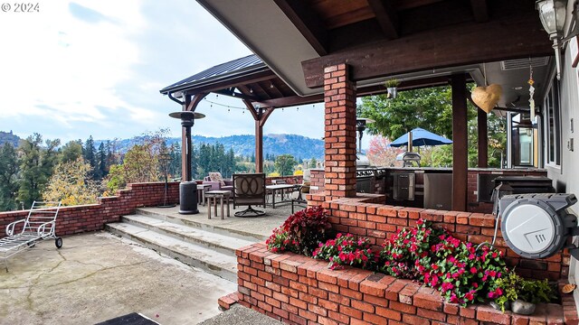 1081 Umpqua College Rd, Roseburg, OR 97470 - view of patio with a mountain view, an outdoor kitchen, and outdoor dining space