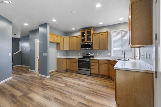 kitchen featuring sink, stainless steel appliances, and light wood-type flooring