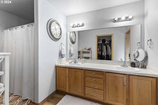 bathroom with vanity, a textured ceiling, and a shower with shower curtain