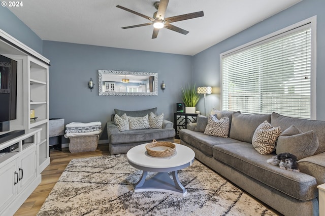 living room featuring ceiling fan and light hardwood / wood-style floors