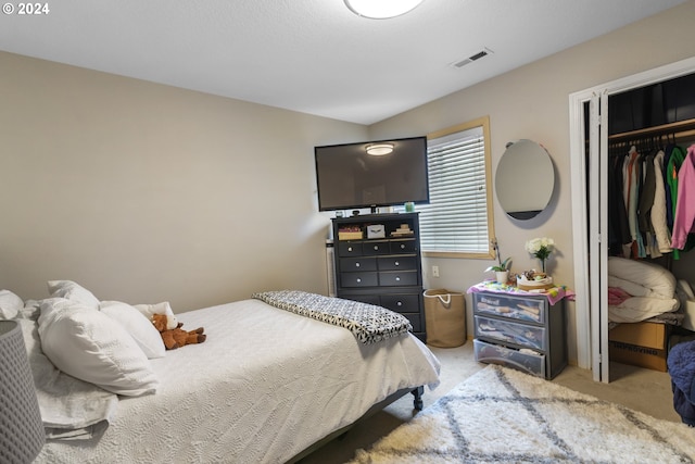 carpeted bedroom featuring a closet