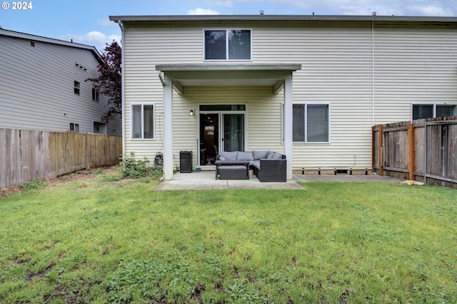 back of property with a lawn, a patio area, and an outdoor living space