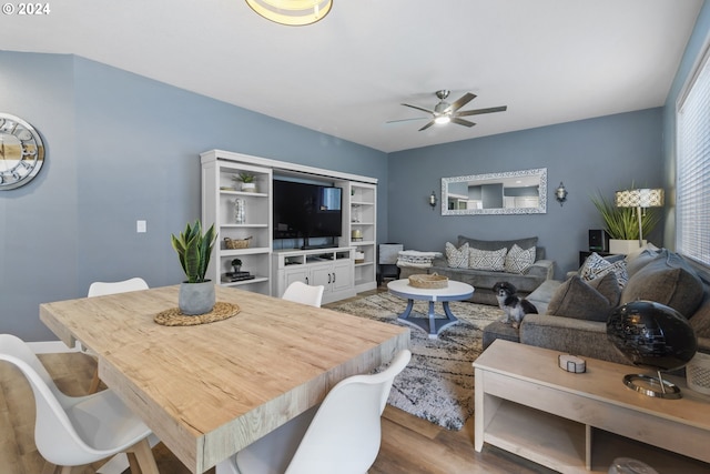 living room featuring hardwood / wood-style floors and ceiling fan