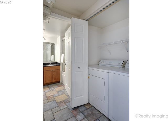 laundry room with washer and clothes dryer and sink