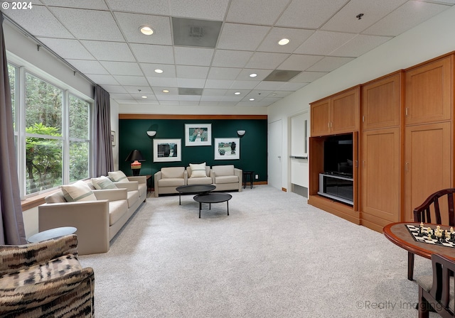 living room with light colored carpet and a drop ceiling