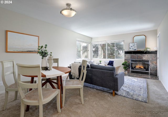 dining area featuring carpet floors and a tile fireplace