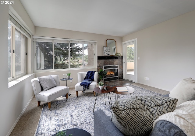 living room with carpet flooring and a tiled fireplace