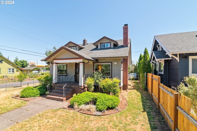 bungalow-style home featuring a front lawn