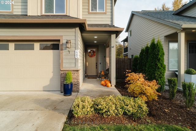 doorway to property with a garage