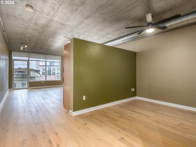 spare room with ceiling fan and light hardwood / wood-style flooring