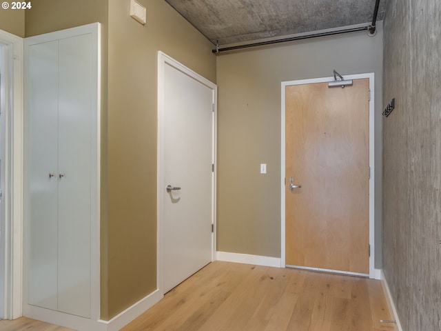 hall with light hardwood / wood-style floors