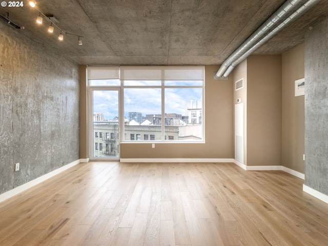 spare room featuring light hardwood / wood-style flooring