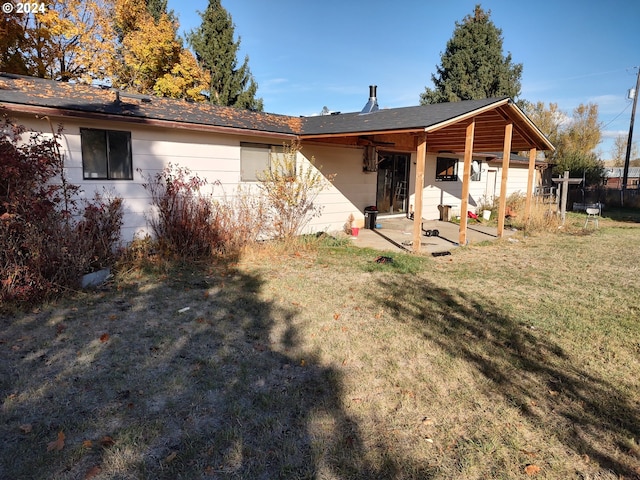 back of house with a patio and a yard