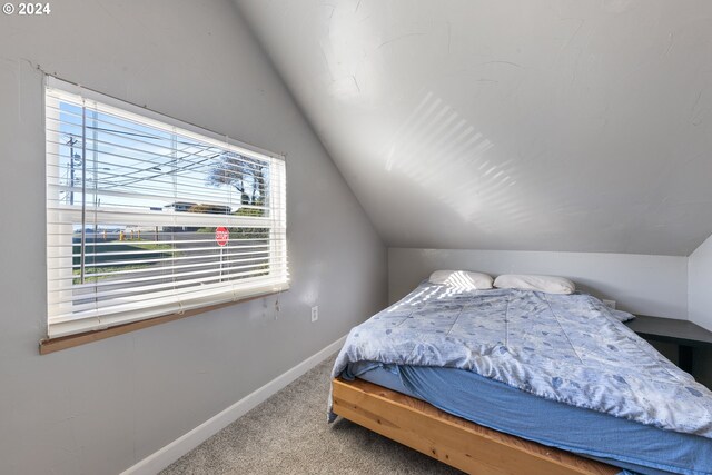 carpeted bedroom with vaulted ceiling