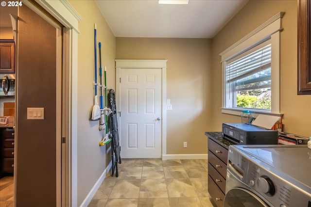 washroom with light tile patterned flooring and cabinets