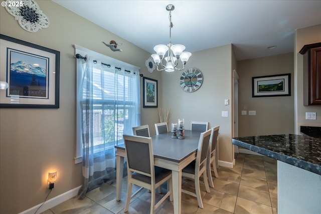 dining room featuring baseboards, a chandelier, and light tile patterned floors