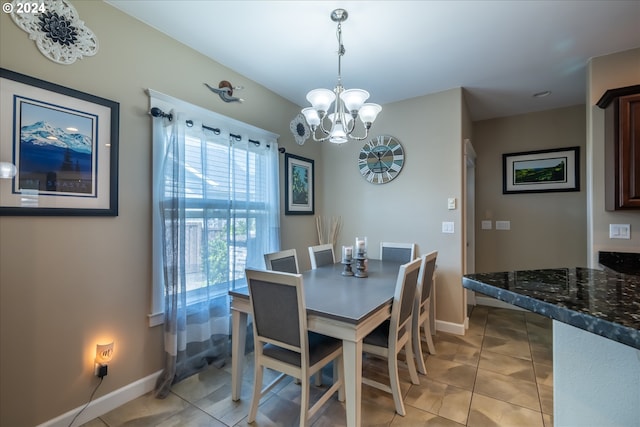 tiled dining space featuring a notable chandelier