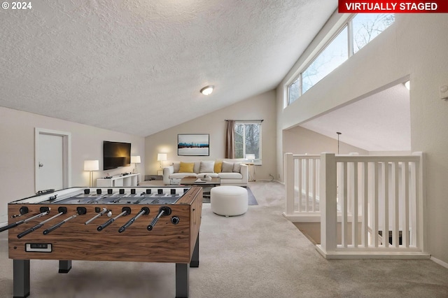 rec room with carpet flooring and a textured ceiling