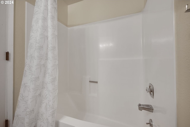 bathroom with shower / bath combination with curtain