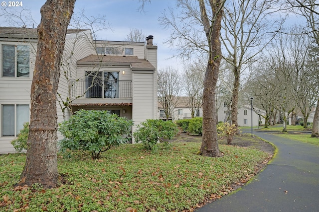 view of side of property featuring a balcony