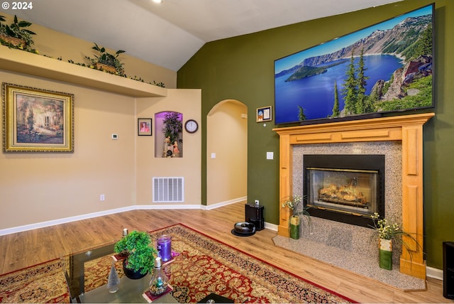 living room with lofted ceiling and hardwood / wood-style flooring