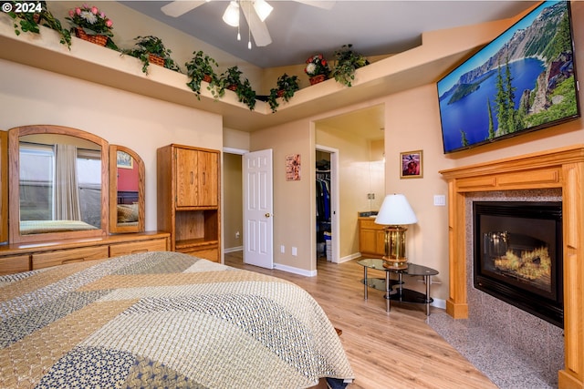 bedroom with a closet, light hardwood / wood-style floors, a spacious closet, and ceiling fan