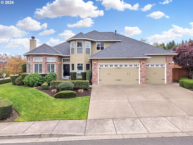 view of front facade featuring a garage and a front lawn