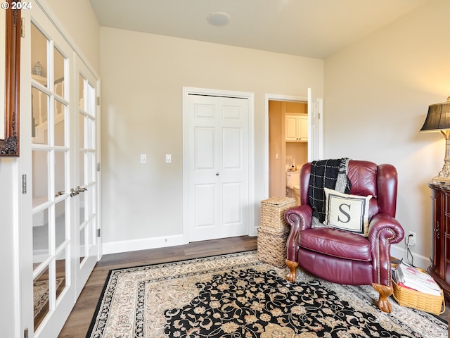 sitting room with dark hardwood / wood-style flooring and french doors