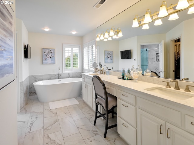 bathroom with vanity and separate shower and tub