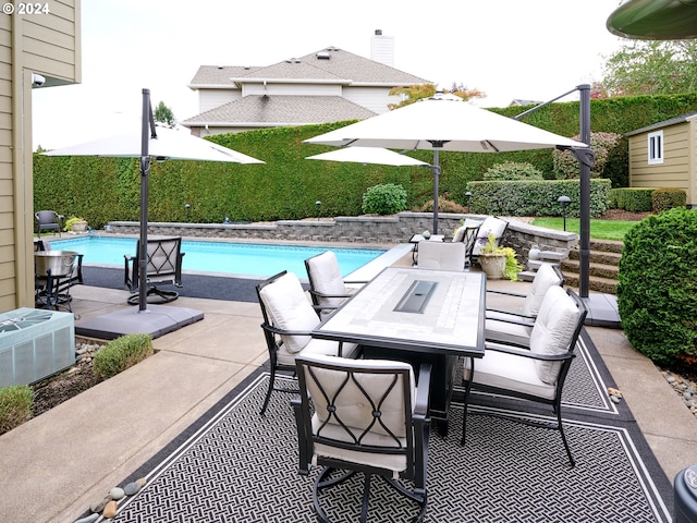 view of patio / terrace featuring a fenced in pool and central air condition unit