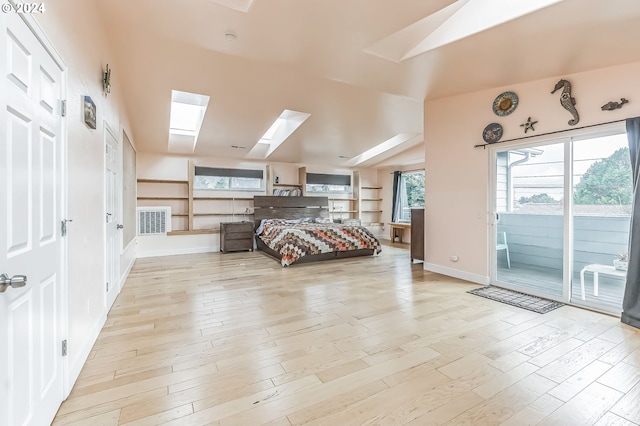 314 S Hazel St, Brookings, OR 97415 - bedroom featuring a skylight, access to exterior, light wood-type flooring, baseboards, and vaulted ceiling