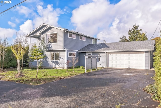 front of property featuring a garage and a front lawn