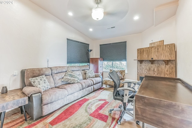 office featuring ceiling fan, vaulted ceiling, and light wood-type flooring