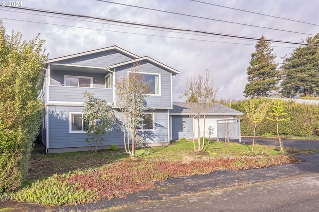 view of front of home with a balcony and a garage