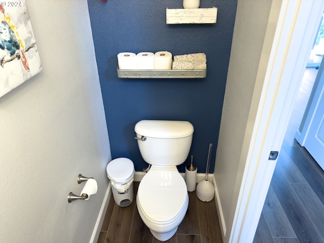 bathroom featuring hardwood / wood-style floors and toilet