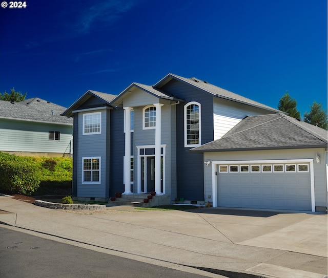 traditional home featuring concrete driveway, crawl space, a garage, and a shingled roof