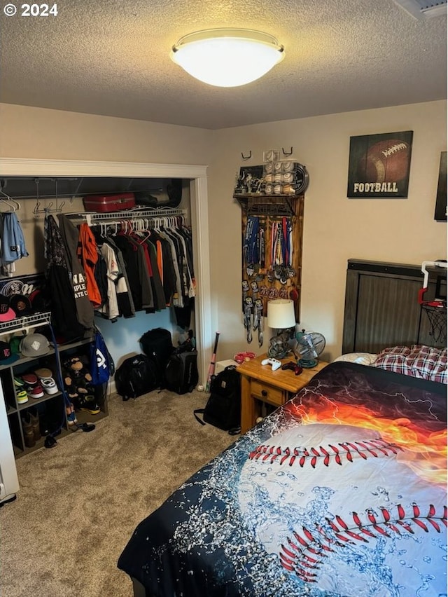 carpeted bedroom featuring a textured ceiling and a closet