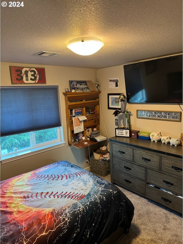 bedroom featuring a textured ceiling and carpet