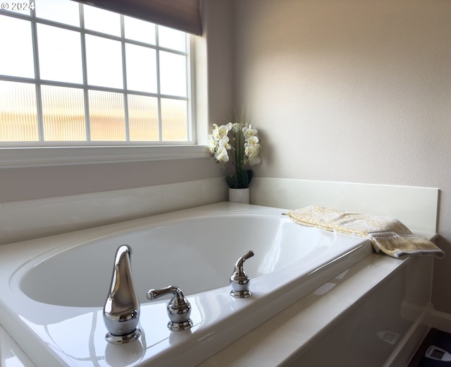 bathroom with a tub to relax in