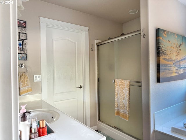 bathroom with sink and plus walk in shower