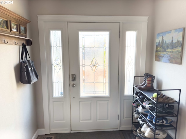 foyer entrance featuring a wealth of natural light and baseboards