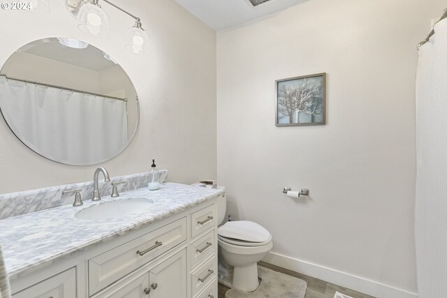 bathroom with vanity and toilet